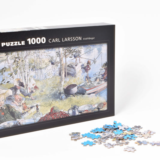 förpackning till pussel med motiv av carl larssons kräftfångst