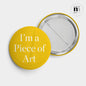 rund pin med nål i gult och texten I'm a piece of Art från Nationalmuseum
