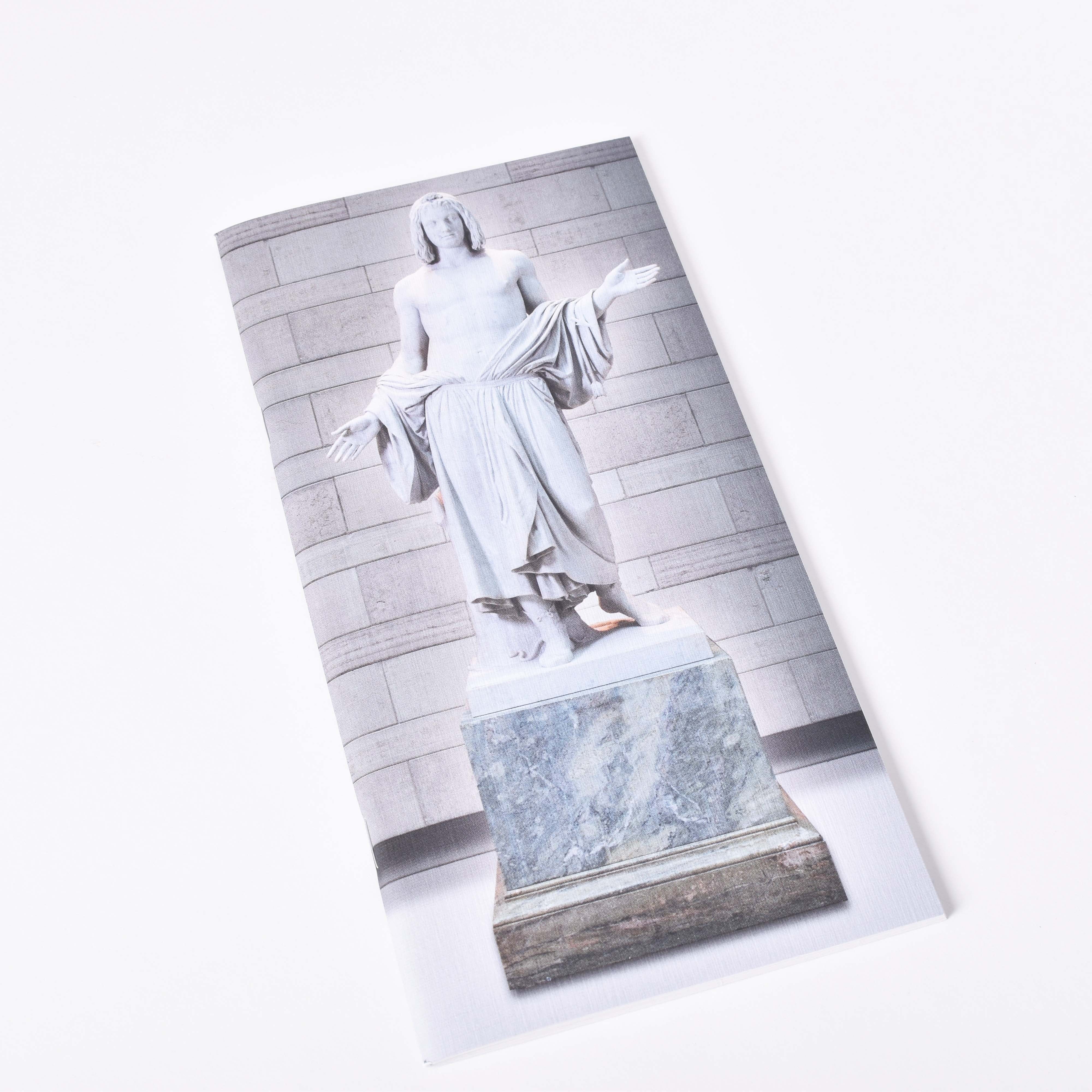 Anteckningsbok med vita sidor och skulpturen Balder i Skulpturgården på Nationalmuseum